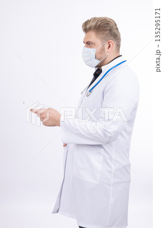 Male doctor in white coat using a smartphone 135295171