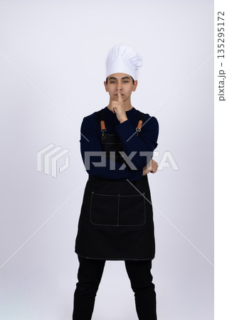 Pensive chef thinking about new recipe in kitchen 135295172