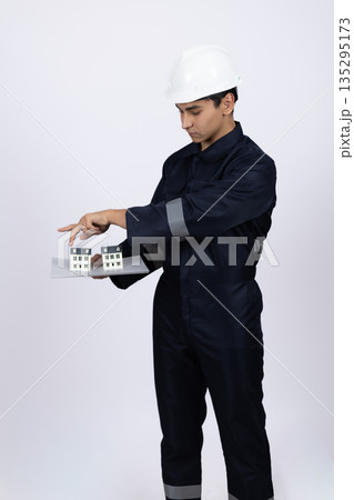 Professional worker in uniform looking at clipboard Professional worker in uniform looking at clipboard 135295173
