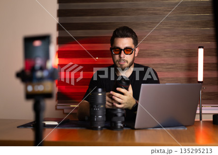 Blogger recording video with laptop and gear Blogger recording video with laptop and gear 135295213