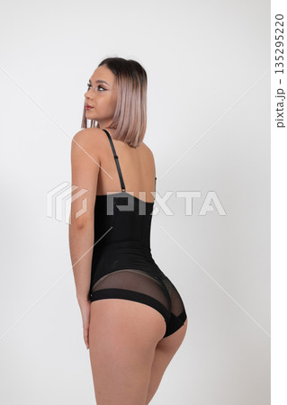 Back view of woman in black bodysuit 135295220