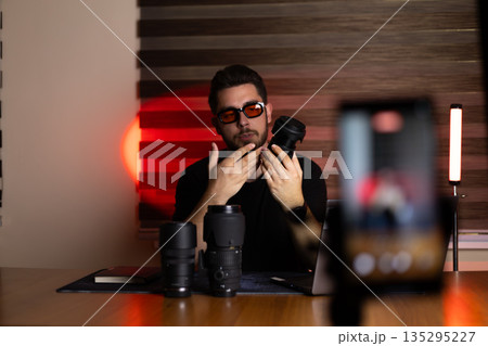 Content creator filming a vlog with camera 135295227