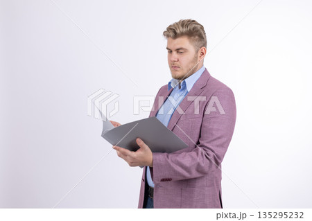 Businessman in purple jacket reading documents Businessman in purple jacket reading documents 135295232