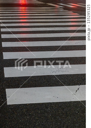 濡れた路面に光が反射する横断歩道_縦 濡れた路面に光が反射する横断歩道_縦 135295325