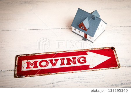Moving Concept With House Model On White Wooden Background Moving Concept With House Model On White Wooden Background 135295349