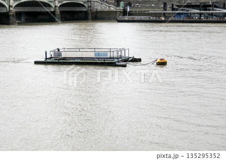 Floating Platform on River. Urban Waterway Scene with Chain and Mooring Buoy 135295352