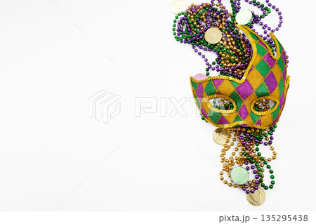 Mardi gras mask beads and festive carnival coins Mardi gras mask beads and festive carnival coins 135295438