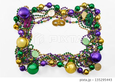 Mardi gras frame with colorful beads and venetian masks 135295443