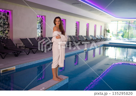 Relaxed dark-haired woman in the swimming pool at spa salon 135295820