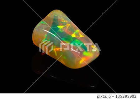 macro mineral stone rare and beautiful opals on a black background 135295902