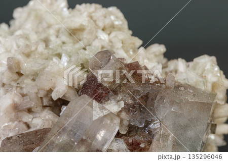 macro mineral stone Apophyllite stilbite on a gray background macro mineral stone Apophyllite stilbite on a gray background 135296046