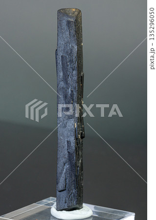 macro mineral stone Ilvaite on a gray background 135296050