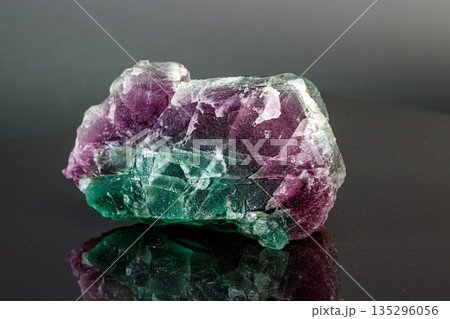 macro mineral stone red and green fluorite on a black background 135296056