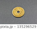 Japanese five yen coin on gray surface closeup. 135296529
