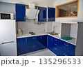 Modern blue kitchen interior with appliances and sink. 135296533