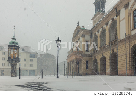 Historic Altermarkt square Magdeburg at heavy snowfall show Rathaus architecture, statues lanterns empty urban space winter storm. Snow covered pavement cold weather dramatic European city atmosphere Historic Altermarkt square Magdeburg at heavy snowfall show Rathaus architecture, statues lanterns empty urban space winter storm. Snow covered pavement cold weather dramatic European city atmosphere 135296746