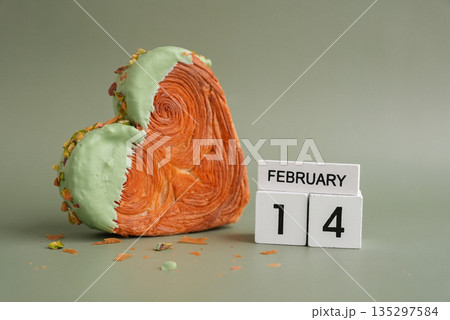 14 February love symbol Delicious fresh croissant topped with Matcha Green Tea flavor Ganache. Creation unique heart shape bakery. Puff pastry holiday love gift present idea Valentine's day 135297584