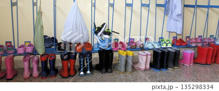 Preschool coat rack with children's backpacks and clothing 135298334