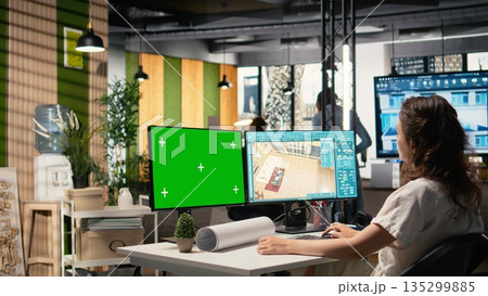 Real estate developer reviews project blueprints with chroma key in a corporate office, planning residential housing and property investment strategies for urban redevelopment. Real estate developer reviews project blueprints with chroma key in a corporate office, planning residential housing and property investment strategies for urban redevelopment. 135299885