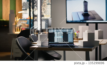 Clean empty workspace of a real estate architecture firm with planning documents, structural designs and digital tools used for urban development and residential project execution. Clean empty workspace of a real estate architecture firm with planning documents, structural designs and digital tools used for urban development and residential project execution. 135299896