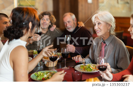 Family having dinner and talking in restaurant 135303237