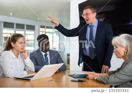Group of different people arguing at table in office 135303343
