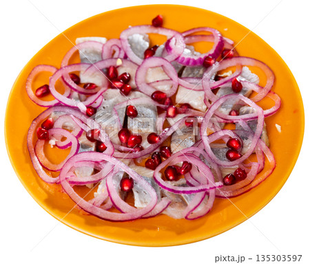 Salted Atlantic herring fillet served with pomegranate seeds 135303597