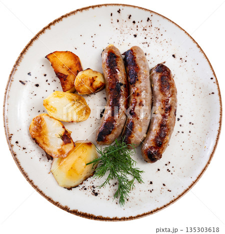Cooked sausages with potatoes on a plate 135303618