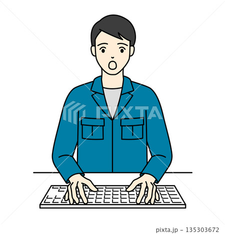 キーボードを叩きながら驚きの表情を見せる作業服の男性 135303672