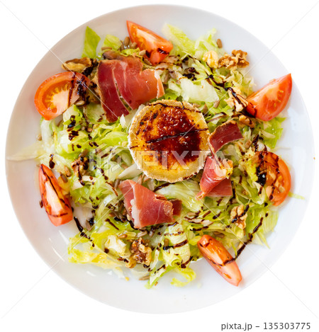 Salad of china cabbage and tomatoes is decorated with thin slices of smoked bacon and goat cheese 135303775
