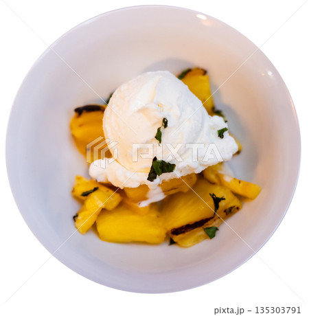 Grilled pineapple slices complemented with vanilla ice cream 135303791