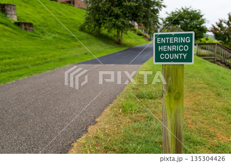 A green sign on a wooden post that says "Entering Henrico County." A green sign on a wooden post that says "Entering Henrico County." 135304426