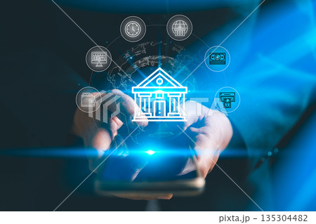 Digital banking concept with hands using smartphone and glowing bank icon, showing mobile payments, online transactions, global finance network and secure fintech services for customers worldwide. Digital banking concept with hands using smartphone and glowing bank icon, showing mobile payments, online transactions, global finance network and secure fintech services for customers worldwide. 135304482