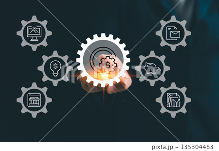 Business finance automation concept with hand touching digital gear and dollar icon, linking banking, budgeting, analytics, reports and savings for efficient financial management and fintech workflow. Business finance automation concept with hand touching digital gear and dollar icon, linking banking, budgeting, analytics, reports and savings for efficient financial management and fintech workflow. 135304483