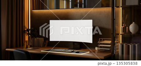 Blank screen computer with gold coins and working material on wooden table with monitor backlighting Blank screen computer with gold coins and working material on wooden table with monitor backlighting 135305838