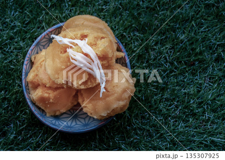 Toddy Palm Cake or Kanom Tarn is local Thai Dessert, sweet, soft and delicious. Made from ripen toddy palm, scraped coconut, and other ingredients, taste delicious. 135307925