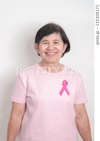 Elderly woman with pink Ribbon for Pink October Breast Cancer Awareness month, May Women Health, February World cancer day, support people life and illness. National cancer survivors month Elderly woman with pink Ribbon for Pink October Breast Cancer Awareness month, May Women Health, February World cancer day, support people life and illness. National cancer survivors month 135308171