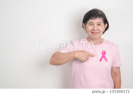 Elderly woman with pink Ribbon for Pink October Breast Cancer Awareness month, May Women Health, February World cancer day, support people life and illness. National cancer survivors month Elderly woman with pink Ribbon for Pink October Breast Cancer Awareness month, May Women Health, February World cancer day, support people life and illness. National cancer survivors month 135308172