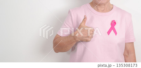 Elderly woman with pink Ribbon for Pink October Breast Cancer Awareness month, May Women Health, February World cancer day, support people life and illness. National cancer survivors month Elderly woman with pink Ribbon for Pink October Breast Cancer Awareness month, May Women Health, February World cancer day, support people life and illness. National cancer survivors month 135308173
