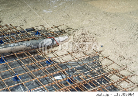 Pouring Concrete Slab Foundation with Reinforcement Steel Mesh, Construction Site Work Pouring Concrete Slab Foundation with Reinforcement Steel Mesh, Construction Site Work 135309964