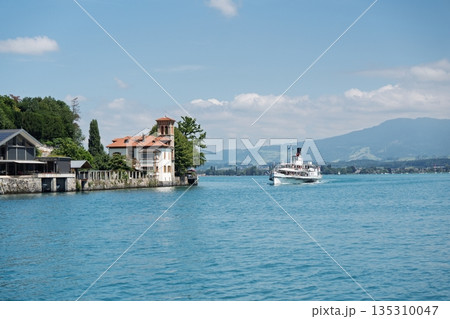 Picturesque Lake Scenery with Historic Building and Steamboat on a Sunny Day, Tourism Picturesque Lake Scenery with Historic Building and Steamboat on a Sunny Day, Tourism 135310047