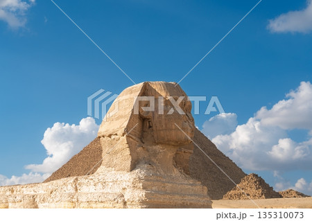 Majestic Sphinx and Pyramid of Giza, Egypt, Under a Bright Blue Daytime Sky. Travel Destination Majestic Sphinx and Pyramid of Giza, Egypt, Under a Bright Blue Daytime Sky. Travel Destination 135310073