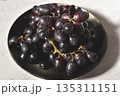 Black grape on black plate. 135311151
