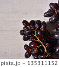 Black grape on white wood background. 135311152