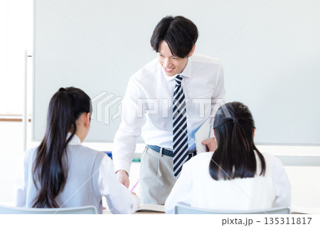 塾で勉強する学生と講師 塾で勉強する学生と講師 135311817