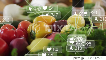 Featuring peppers plums lemons onion and herbs on kitchen counter, with social media overlay icons 135312599
