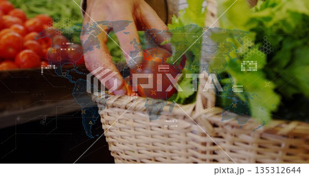 Reaching hand selecting tomato and greens from wicker basket at stall with digital map overlay Reaching hand selecting tomato and greens from wicker basket at stall with digital map overlay 135312644
