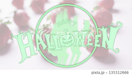Featuring Halloween graphic with jack-o'-lantern and cat silhouettes in studio, with strawberries Featuring Halloween graphic with jack-o'-lantern and cat silhouettes in studio, with strawberries 135312666