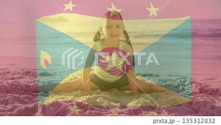 Girl performing split on sandy beach in sportswear, with yoga mat and semi transparent flag overlay Girl performing split on sandy beach in sportswear, with yoga mat and semi transparent flag overlay 135312832