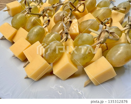 New Year's snack skewers hard cheese with grapes on the festive table 135312876